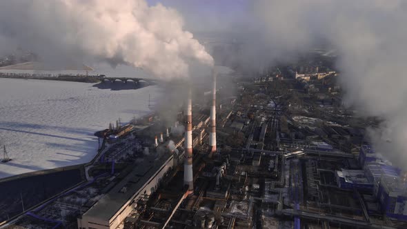 Factory emissions of smoke from factory pipes in indistrial zone alt