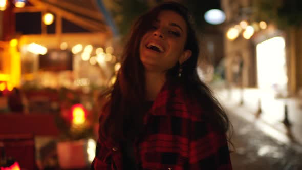 Girl in a Plaid Shirt on the Evening Street alt