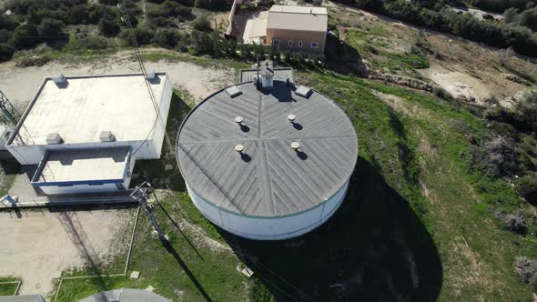 Topdown view white circular storage tanks, Aerial rotation. Algarve, Portugal