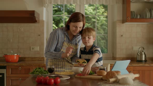 Woman and Kid Making Burgers at Home Together alt
