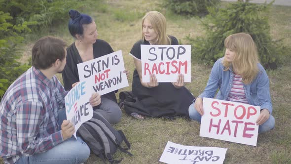 Sit-in Protest of Caucasian People Against Human Rights Violation. Male and Female Activists with alt