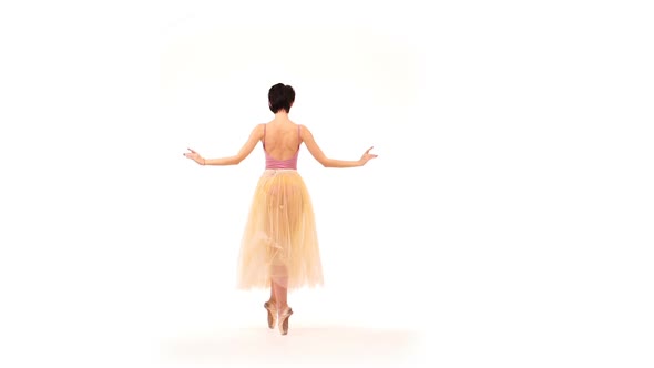 Ballerina Is Dancing in the Studio on a White Background - 