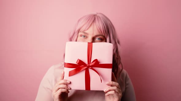 Beautiful Young 30s Caucasian Woman in Love Holding Present Gift Box with Red Ribbon Bow Posing