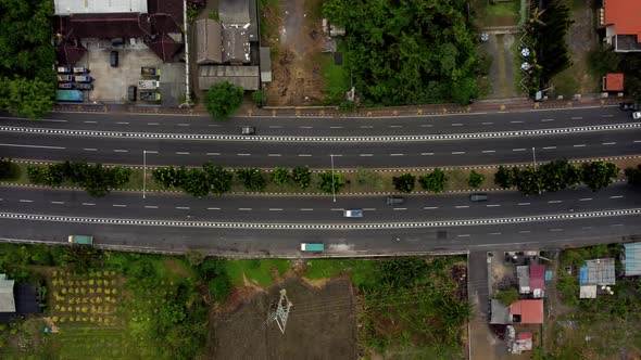Top down view aerial road in cloudy day in Bali alt