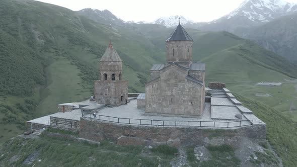 Stepantsminda, Georgia - May 8 2021: Aerial view of Gergeti Trinity Church, Tsminda Sameba. Kazbegi alt