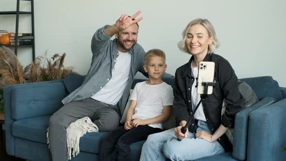 Happy family of four members cheerfully taking selfie. Sleepy kids, moments of happiness