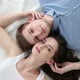 Young Loving Couple Lying on Bed at Home - VideoHive Item for Sale