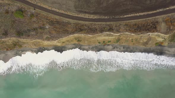 Aerial view to a steep shore and big waves