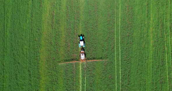 Tractor Sprays a Field Aerial View