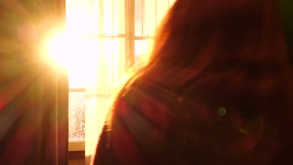 Girl Opening A Window And Looking At The Evening City 2 alt