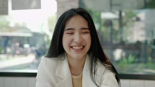 Asian woman is greeting through video calls, she is with friends online via social media. alt