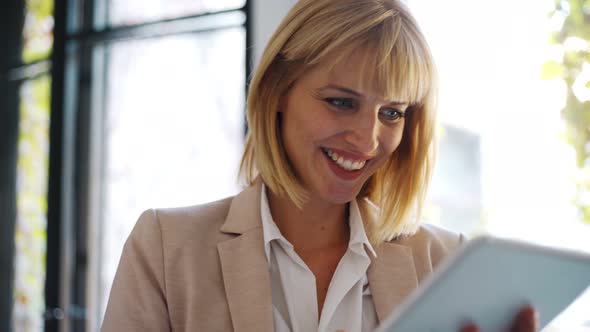 Businesswoman using tablet at office alt