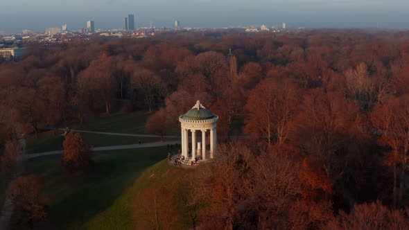 Epic Scenic Aerial Slide Circle Around The Monopteros in English Garden in Munich, Germany alt