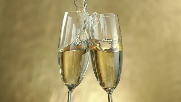 Super Slow Motion Shot of Toasting on Golden Luxury Background at 1000Fps alt
