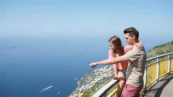 Summer Holiday in Italy. Young Man and Little Daughter on the Background, Amalfi Coast, Italy alt