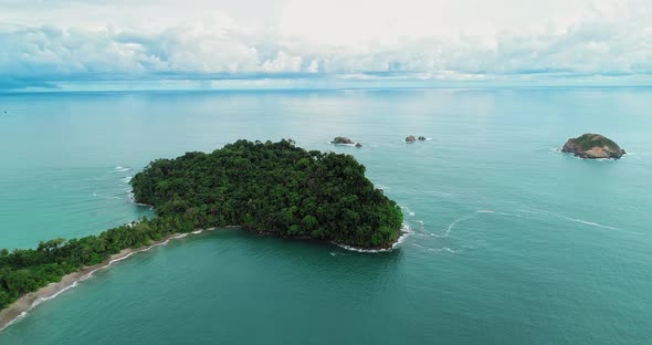 Aerial video of a part of forest/land in the sea, in Manoel Antonio , Costa Rica. alt