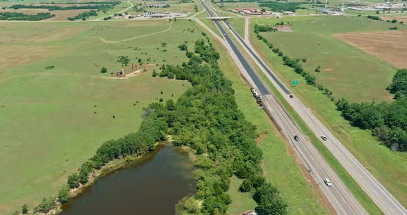 Oil Pump in the Countryside the Small Pond Near Historic Road 66 in Clinton Oklahoma on Aerial View alt