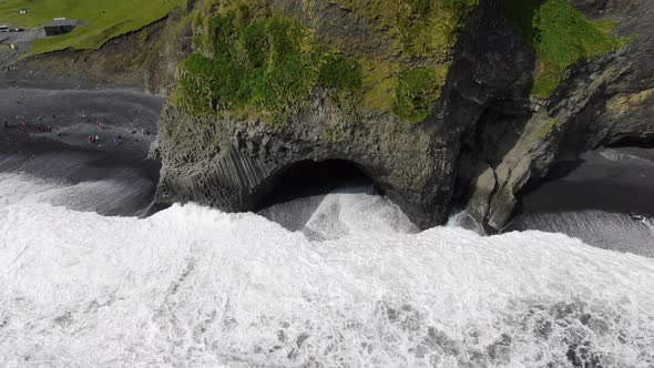 Basalt columns and a cave at Reynisfjara black sand beach in Iceland alt