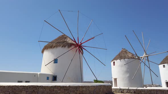 Mykonos Best Attraction Traditional Windmill  Blue Sky 4k 60 fps Pan Right alt