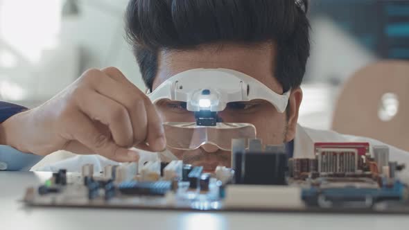 Electronics Engineer Repairing Motherboard alt