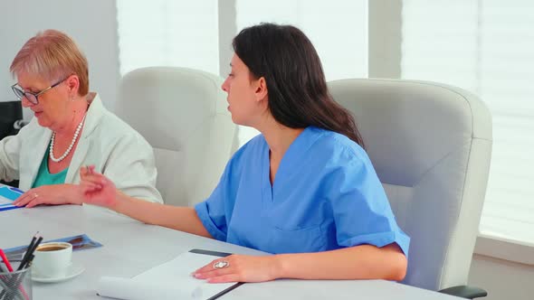 Close Up of Medical Nurse Taking Notes on Clipboard During alt