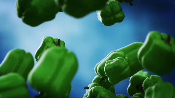 Slow motion animation of natural green bell peppers falling down. Loopable. HD alt