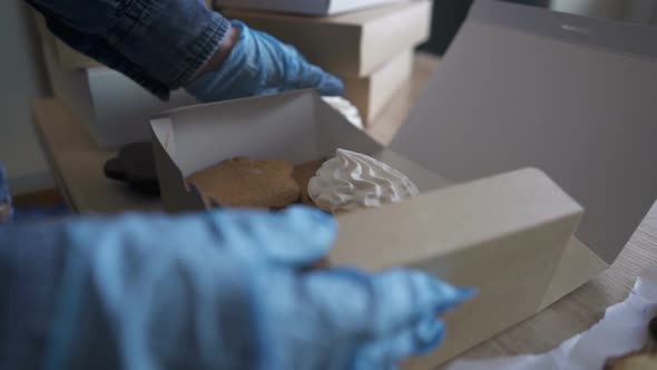Homemade Pastry Delivery. Cake Shop Business. Woman Putting Cupcakes in Box.