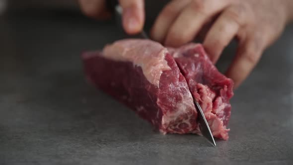 Chef cutting beef fillets for barbecue