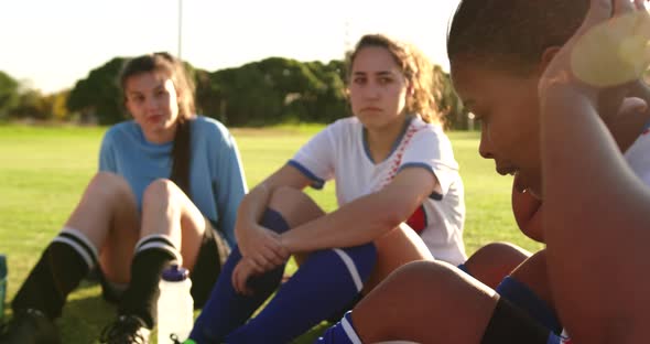 Female soccer team in break time talking on soccer field. 4k alt