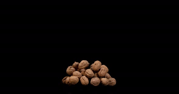 Walnut, juglans regia, Fruits falling against Black Background, Slow Motion 4K alt