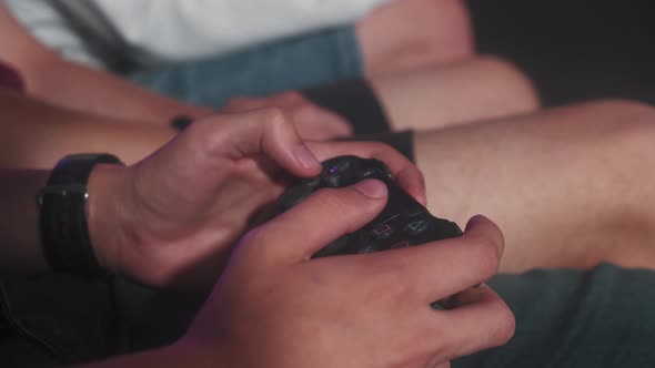 Closeup of a Man's Hand Holding a Joystick and Playing Video Games alt