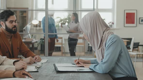 Happy Woman in Hijab Singing Contract with HR alt