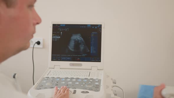 Pregnant Woman with Caring Husband Visiting Medical Clinic for Regular alt