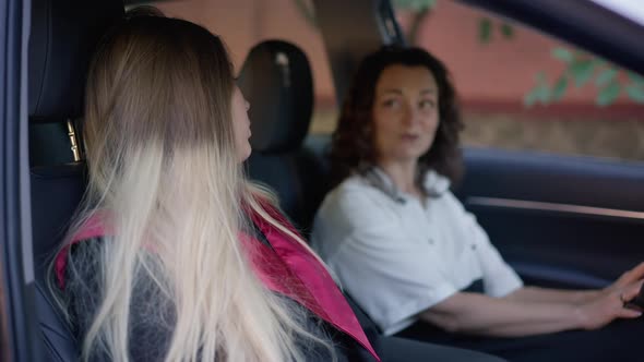 Side View Happy Graduated Woman in Graduation Gown Talking with Mother Laughing in Slow Motion alt