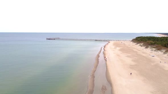 Flying away from Palanga bridge over sandy Lithuania coastline alt