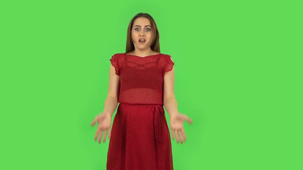 Tender Girl in Red Dress Is Upset, Waving Her Hands in Indignation, Shrugging. Green Screen alt