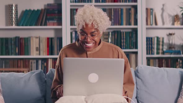 African Woman Looking at Laptop Screen Reading Email with Unbelievable Win News alt