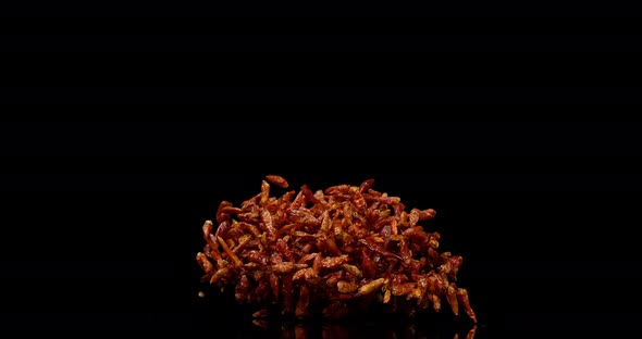 Cayenne Chili Pepper, capsicum frutescens, spice falling against Black Background, Slow Motion 4K alt