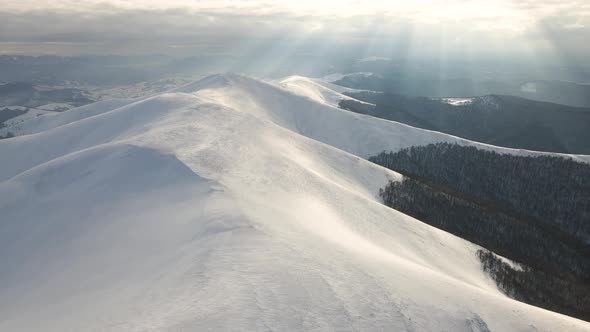Amazing Aerial Flight Over Misty Mountain Range Meadows and Snow Covered Peaks in Winter Time alt