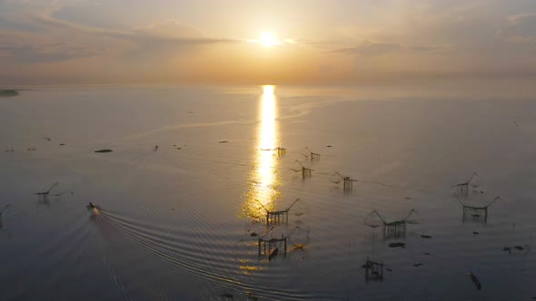 Local fishing trap net in canel, lake or river at sunset. Nature landscape fisheries and fishing alt