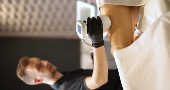 Man Doing Ultrasound Liposuction Procedure in Medical Clinic alt