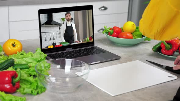 Woman Housewife Greets Listen Chef Slices Cucumber Watch Online Cooking Course alt