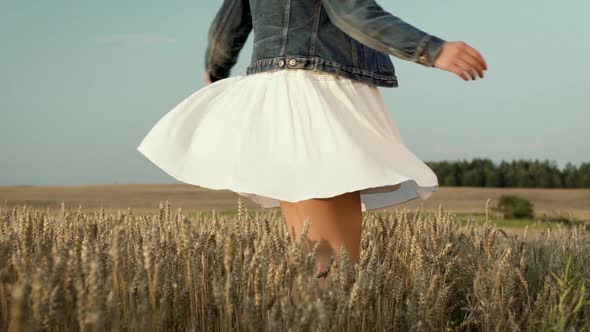 Woman With White Skirt Dancing In Wheat Field