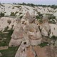 Aerial backward moving shot of rocky landscape with unusual rock formation called fairy chimneys in - VideoHive Item for Sale