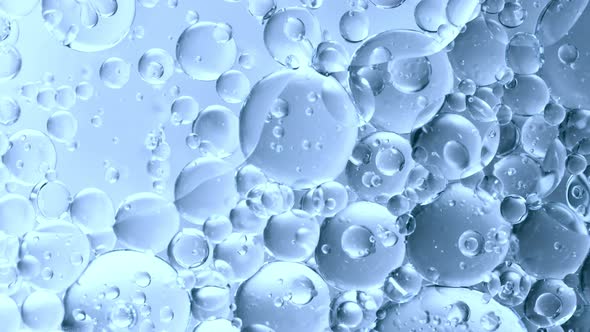 Super Slow Motion Shot of Moving Gel Bubbles on Light Blue Background at 1000Fps alt