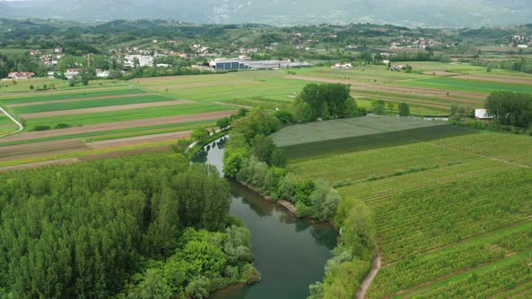 The beautiful countryside of Vipava in Slovenia with river, agricultural fields and houses in the ba alt