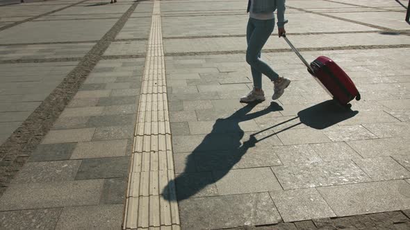 A Young Woman is Walking Through the Train Station alt