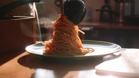 Cook Serving Spaghetti on the Plate