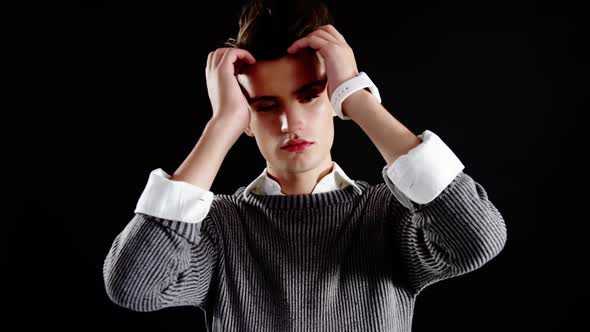 Androgynous man posing against black background alt