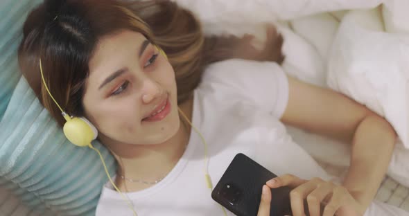 Close Up Happy Asian Woman Listening To Music By Headphones. alt